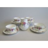 Four Wedgwood Bone China Breakfast Cups and Saucers along with a Milk Jug  decorated with floral