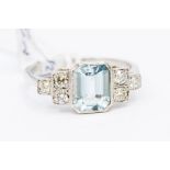 An aquamarine and diamond platinum ring, the central rub over set aquamarine measuring approx 1.