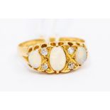 A Victorian opal and diamond ring 18ct gold, comprising three oval opals with alternate diamond