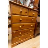 A contemporary hand finished pine bedroom suite, comprising triple sectioned wardrobe, with two
