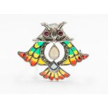 A plique a jour silver brooch/pendant in the form of an owl set with an opal and faceted garnets and