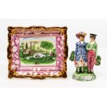 An early 19th Century Staffordshire figure group, depicting a lady and gentleman, the lady with a
