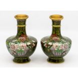 A pair of Chinese Cloisonné vases, having floral decoration on a green ground