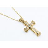 A 9ct gold and diamond cross with diamond set bail, length approx 35mm, on fine link chain, length