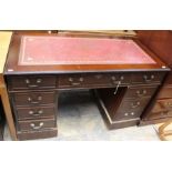 A reproduction traditional style twin pedestal desk