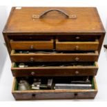 An early 20th Century oak tool chest, fitted with four small drawers and three long drawers,