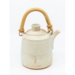 Mary Rich, Studio pottery. A celadon glazed tea kettle with bamboo handle.