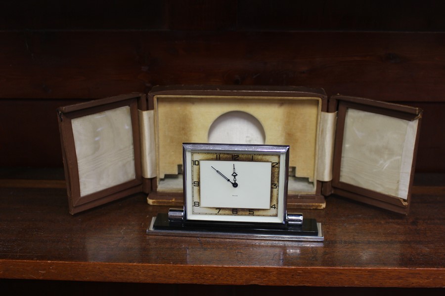 An Art Deco travel clock by Smiths in original fitted leather case