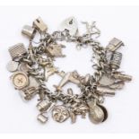 A sterling silver charm bracelet, fitted with approx 30 charms, including an Elizabethan coin,