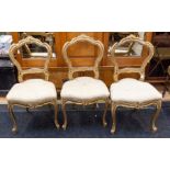 A set of three 19th Century gilt wood French style parlour chairs, raised on cabriole legs
