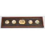 A set of four late 19th Century Japanese Meiji period buttons, together with an oblong plaque each
