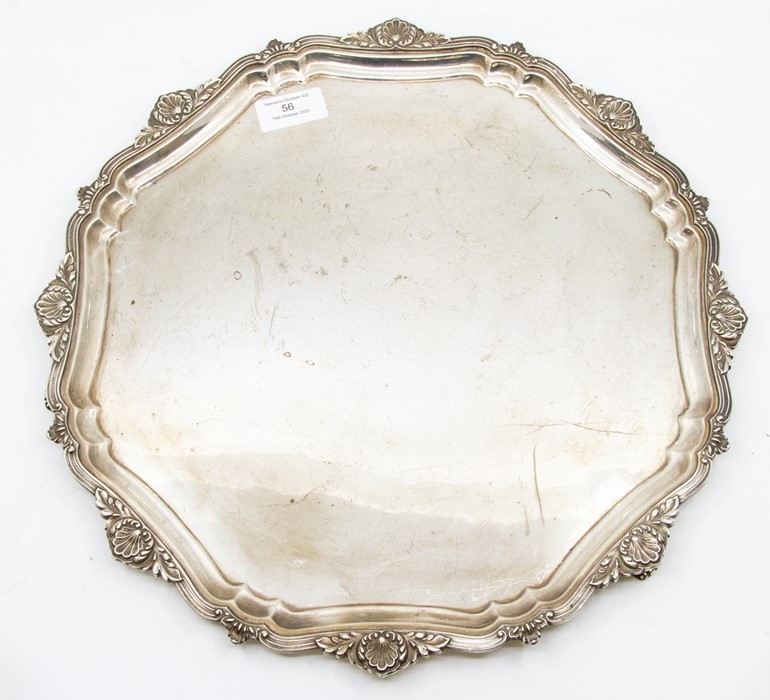 An Elizabeth II silver shaped circular large salver, scrolling border with shell and foliate