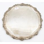 An Elizabeth II silver shaped circular large salver, scrolling border with shell and foliate