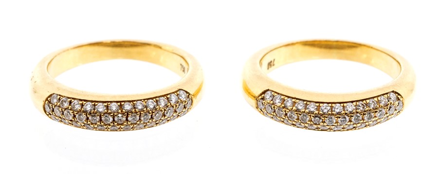 Two diamond and 18ct gold rings, each comprising a domed band pave set with three rows of round