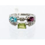 An 18k white gold and mult-gem ring, size M1/2, approx 6gms Condition report: good, no obvious signs