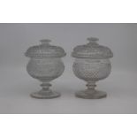 A pair of mid Victorian cut glass sweetmeat vases and covers, circa 1860, of rounded form with