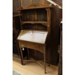 An Edwardian mahogany writing cabinet, fitted with shelves above and a fall front section, 145cm