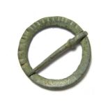 Medieval Brooch. Circa 13th century. Copper-alloy, 4.91 grams. 28.79 mm. An annular brooch with