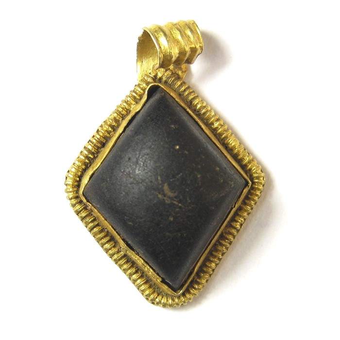 Anglo-Saxon Pendant Circa 6th century AD. Gold, 2.14 grams. 21.04 x 14.68 mm. A lozenge-shape