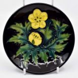 A Moorcroft Buttercup coaster designed by Sally Tuffin, circa 1990, shape no 780/4, 4" diam