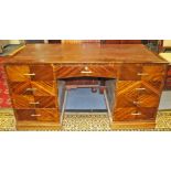 An early 20th Century Art Deco American walnut twin pedestal desk, the pedestals interconnected,