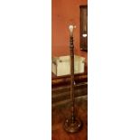 ****** ITEM LOCATION BISHTON HALL********** A 20th Century oak standing lamp with a fluted column;