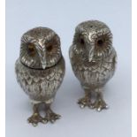 A pair of Elizabeth II silver pepperettes, realistically cast as owls, glass eyes, Garrard & Co,