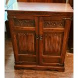 ****** ITEM LOCATION BISHTON HALL********** A 20th Century oak carved television cabinet. 102cm H