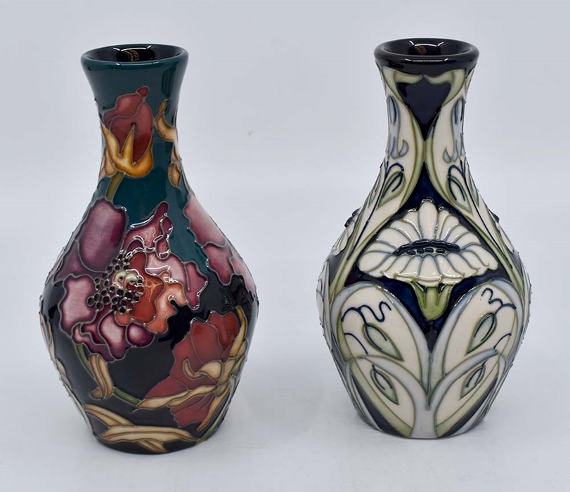 Moorcroft: 2 contemporary Moorcroft floral pattern vases. Height approx 13cm. Marks to the bases.