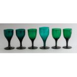 A mixed group of 19th Century green glass wines, ogee bowls, plain and knopped stems, height 12.