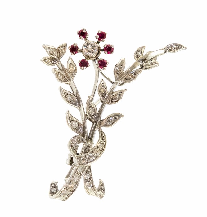 A circa 1950's platinum diamond and ruby set floral spray brooch with eight cut diamonds and