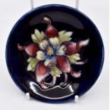 A Moorcroft Columbine on cobalt blue footed bowl,