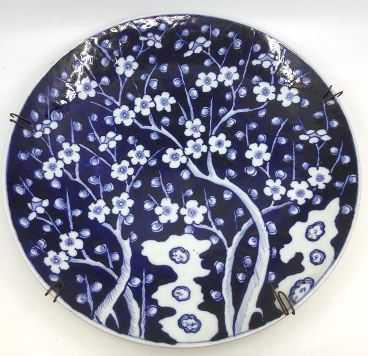 A Chinese blue and white charger decorated with prunus tree, the reverse with central character mark