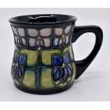 A Moorcroft Violet mug designed by Sally Tuffin, date circa 1991, approx 4" high Condition Report: