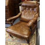 A late Victorian brown leather upholstered gentleman's armchair in the manner of Schoolbred buttoned
