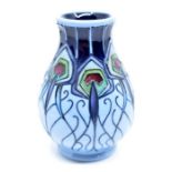 Moorcroft: A Moorcroft 'Peacock Parade' vase by Nicola Slaney. Height approx 10cm. Signature in gold