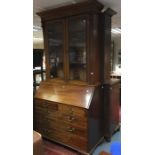 A George III mahogany bureau and later bookcase, the Victorian upper section of circa 1870, fitted