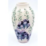 Moorcroft: A Moorcroft Club vase 'Lavender?' pattern. Height approx 13.5cm. Marks to the base.