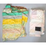 A Victorian patchwork quilt in an assortment of colours and various designs, torn in places,