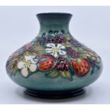 Moorcroft: A Moorcroft 'Carousel' pattern squat vase No 102. Height approx 10.5cm. Marked to base.