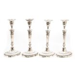 A set of four late Victorian silver candlesticks in the neo classical style, each with detachable