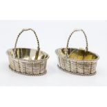 A pair of George III silver and parcel gilt oval basket shaped salts with rope twist borders and