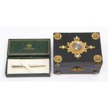 A North European style gilt and white metal mounted ebonised jewellery box, the cover inset with