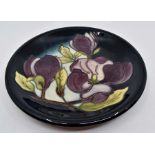 A Moorcroft Magnolia plate designed by Walter Moorcroft, date 1992, 22cm diam and a Magnolia