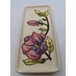 A Moorcroft Magnolia oblong tray designed by Walter Moorcroft, date 1998, 20 x 9cm., boxed Condition