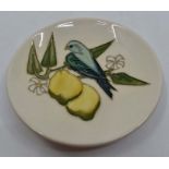 A Moorcroft Lemons coaster designed by Sally Tuffin, date 1990, 11.5cm diam, with box and sleeve