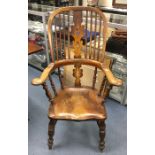 A Victorian ash and elm Windsor armchair, hooped back rail, central shaped back splat with pierced