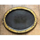 A 19th Century oval black papier mache drinks tray by Clay of London, gilt metal handles, gilt