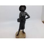 An Art Deco style spelter figure of a Spanish dancer wearing Cordobes hat and tasselled off the