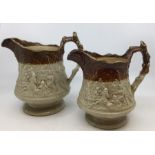 A pair of Victorian graduating stone ware jugs, the bodies with camp fires scenes in high relief (2)